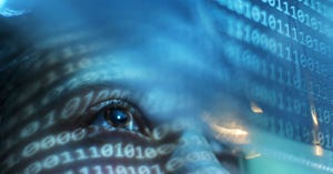 Portrait of person looking on blue screen lit with binary code