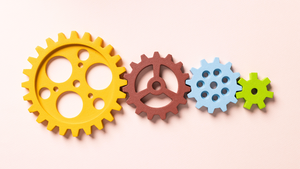 four colorful cogs of different sizes fitted together