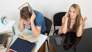 worker frustrated by coworker's loud talking on the phone